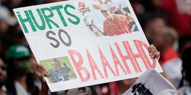 A fan holds a sign that reads, "Hurts So Baaahhd." during the NFC Wild Card Playoff game between the Philadelphia Eagles and the Tampa Bay Buccaneers at Raymond James Stadium on January 16, 2022 in Tampa, Florida.