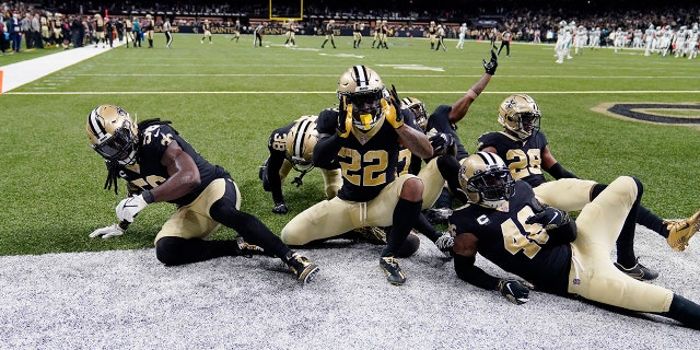 New Orleans Saints defensive back Chauncey Gardner-Johnson (22) celebrates his interception with teammates in the second half of an NFL football game against the Carolina Panthers in New Orleans, Sunday, Jan. 2, 2022. The Saints won 18-10.