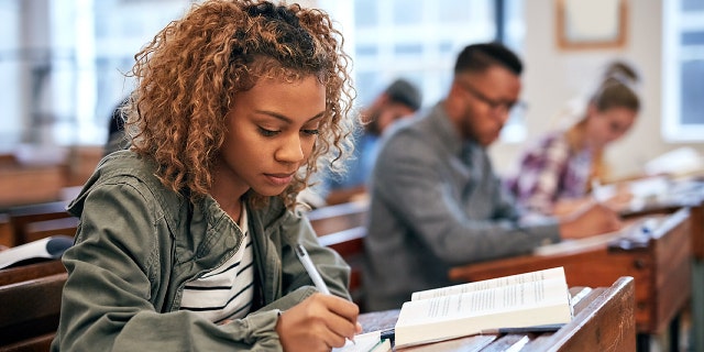 Cropped shot of university students sitting in class