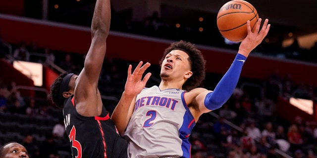 Detroit Pistons guard Cade Cunningham (2) is defended by Toronto Raptors forward Pascal Siakam (43) during the first half of an NBA basketball game, Friday, Jan. 14, 2022, in Detroit.