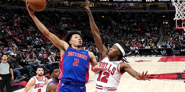 Detroit Pistons' Cade Cunningham (2) shoots over Chicago Bulls' Ayo Dosunmu during the second half of an NBA basketball game Tuesday, Jan.. 11, 2022, in Chicago. The Bulls won 133-87.