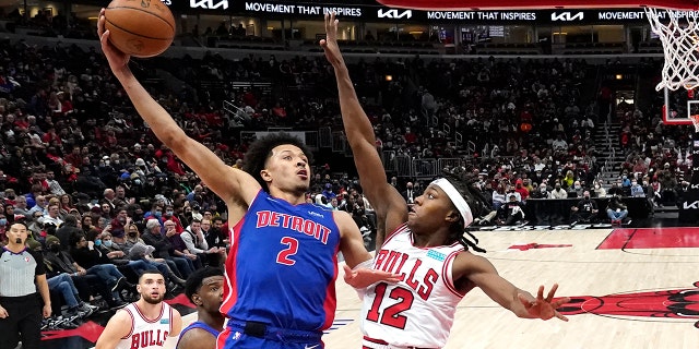 Detroit Pistons' Cade Cunningham (2) shoots over Chicago Bulls' Ayo Dosunmu during the second half of an NBA basketball game Tuesday, Jan. 11, 2022, in Chicago. The Bulls won 133-87.