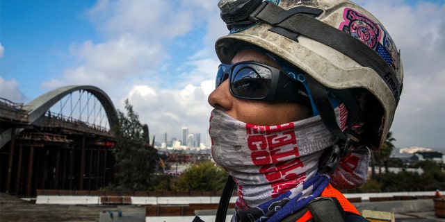 Iris Rivera part of crew removing falsework under the viaduct at Sixth Street bridge, Oct. 23, 2021 in Los Angeles.