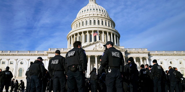 A large group of police arrive at the Capitol, Thursday, Jan. 6, 2022, in Washington. President Biden and members of Congress are marking one year since the Jan. 6 U.S. Capitol insurrection. 