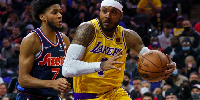 Los Angeles Lakers' Carmelo Anthony, 对, drives to the basket against Philadelphia 76ers' Isaiah Joe, 剩下, during the first half of an NBA basketball game, 星期四, 一月. 27, 2022, 在费城.