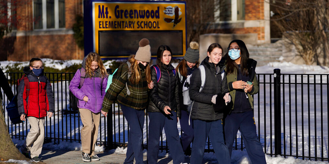 Students at the Mt. Greenwood Elementary School in Chicago depart after a full day of classes Monday, Jan. 10, 2022.