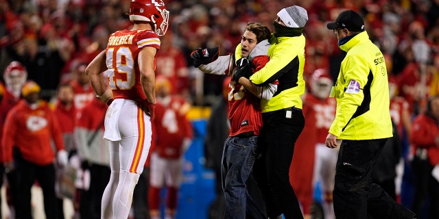 Jan 23, 2022; Kansas City, Missouri, USA; Kansas City Chiefs safety Daniel Sorensen (49) looks on a security removes a fan who ran onto the field during the second half of the AFC Divisional playoff football game against the Buffalo Bills at GEHA Field at Arrowhead Stadium.