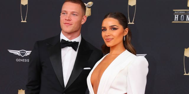 Olivia Culpo soaked up the sun in Mexico with Christian McCaffrey (seen here) and her sister Aurora.