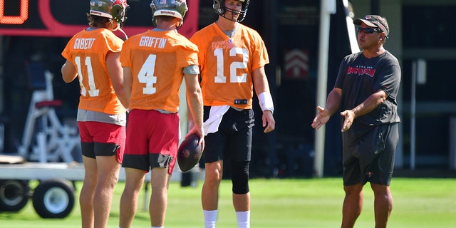 Blaine Gabbert (11), Ryan Griffin (4) and Tom Brady (12) of the Tampa Bay Buccaneers meet with quarterback coach Clyde Christensen during the Buccaneers mini-camp at AdventHealth Training Center June 10, 2021, in Tampa, Fla.