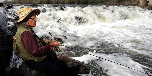 Ronnie Crawford fishes the South Platte River in Denver May 13, 2013. 