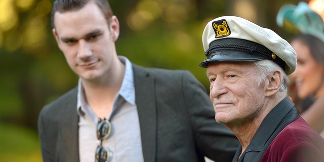 Cooper Hefner (L) has defended his father on Twitter.