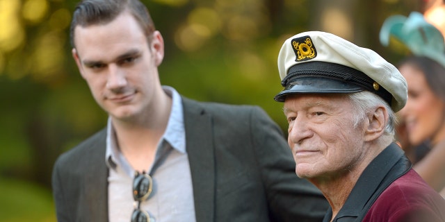 Cooper Hefner and Hugh Hefner pose at Playboy's 60th Anniversary special event on Jan. 16, 2014, in Los Angeles, California.