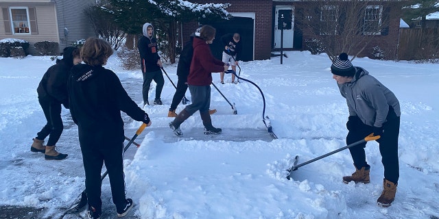 The football players didn’t just shovel driveways on Monday. They also shoveled more driveways together on Tuesday. 