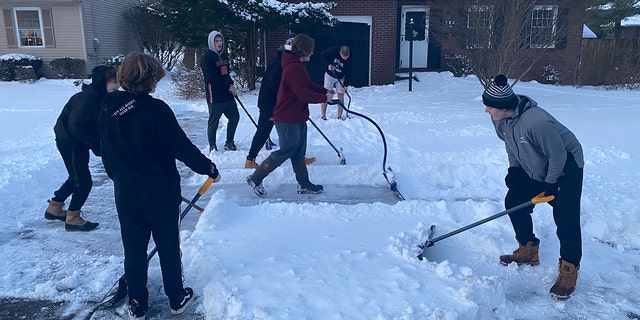 The football players didn’t just shovel driveways on Monday. They also shoveled more driveways together on Tuesday. 