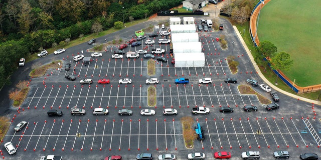 FILE: Cars line up at a COVID-19 testing site at the South Orange Youth Sports Complex in Orlando. Due to the extreme demand for testing as a result of the spread of the omicron variant, the county opened this site in addition to two other existing sites which have reached capacity on a daily basis, forcing them to close early. (Photo by Paul Hennessy/SOPA Images/LightRocket via Getty Images)