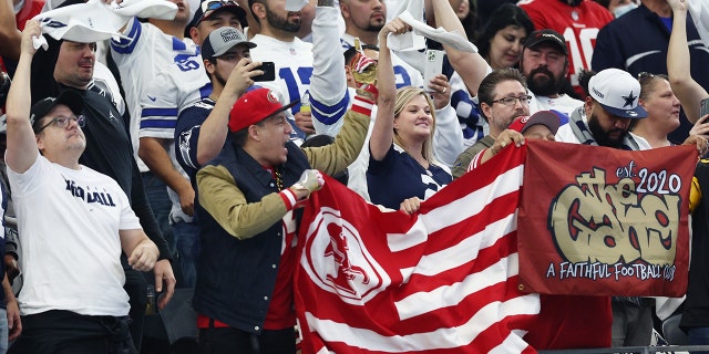 San Francisco 49ers and Dallas Cowboys fans cheer during the first quarter in the NFC Wild Card Playoff game at AT&T Stadium on January 16, 2022 in Arlington, Texas.