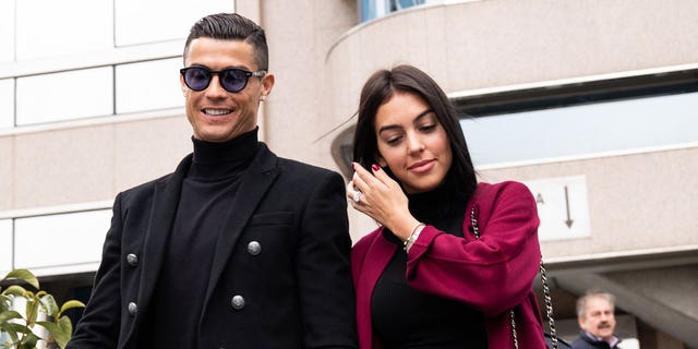 Portuguese soccer player Cristiano Ronaldo leaves the district court in Madrid with his girlfriend Georgina Rodríguez from a tax evasion trial.