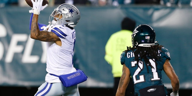 Dallas Cowboys wide receiver Ced Wilson catches a pass over Philadelphia Eagles defensive back Andre Chachere to score a touchdown during the first half of an NFL football game, Saturday, Jan. 8, 2022, in Philadelphia. (AP Photo/Laurence Kesterson)
