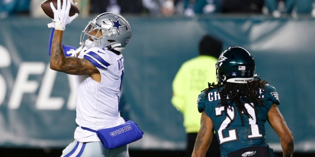 Dallas Cowboys wide receiver Ced Wilson catches a pass over Philadelphia Eagles defensive back Andre Chachere to score a touchdown during the first half of an NFL football game, Saturday, Jan. 8, 2022, in Philadelphia. (AP Photo/Laurence Kesterson)