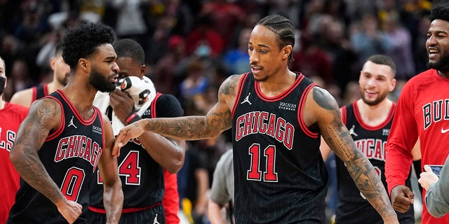 Chicago Bulls' DeMar DeRozan (11) celebrates with Coby White (0) after DeRozan hit the game winning shot during an NBA basketball game against the Indiana Pacers, Friday, Dec. 31, 2021, in Indianapolis. Chicago won 108-106. 