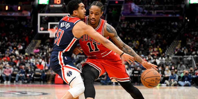 Chicago Bulls forward DeMar DeRozan (11) drives to the basket against Washington Wizards guard Tremont Waters (51) during the first half of an NBA basketball game, 星期六, 一月. 1, 2022, 在华盛顿.