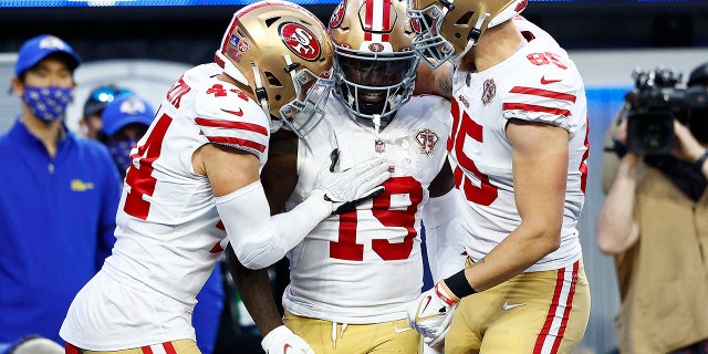 Deebo Samuel #19 of the San Francisco 49ers reacts with teammates Kyle Juszczyk #44 and George Kittle #85 after scoring a touchdown in the second quarter against the Los Angeles Rams in the NFC Championship Game at SoFi Stadium on January 30, 2022 in Inglewood, California.