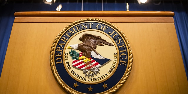 The U.S. Department of Justice seal on a podium in Washington, D.C., on Thursday, Aug. 5, 2021. 