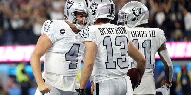 Keenan Allen #13 of the Los Angeles Chargers celebrates his touchdown with teammate Derek Carr #4 during the third quarter against the Los Angeles Chargers at SoFi Stadium on October 04, 2021 in Inglewood, California.