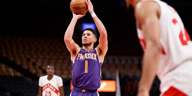 Devin Booker (1) of the Phoenix Suns takes a foul shot during the second half against the Toronto Raptors at Scotiabank Arena Jan. 11, 2022 in Toronto.
