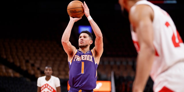 Devin Booker (1) of the Phoenix Suns takes a foul shot during the second half against the Toronto Raptors at Scotiabank Arena Jan. 11, 2022 in Toronto.