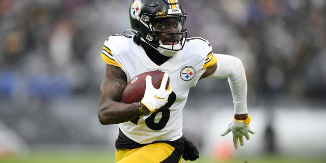 Pittsburgh Steelers wide receiver Diontae Johnson runs with the ball after making a catch against the Baltimore Ravens during the second half of an NFL football game, Sunday, Jan. 9, 2022, in Baltimore.