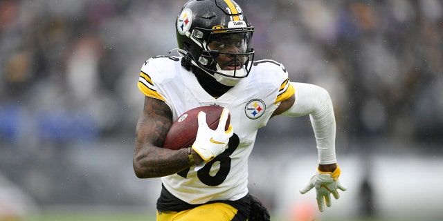 Pittsburgh Steelers wide receiver Diontae Johnson runs with the ball after making a catch against the Baltimore Ravens during the second half of an NFL football game, Sunday, Jan. 9, 2022, in Baltimore.
