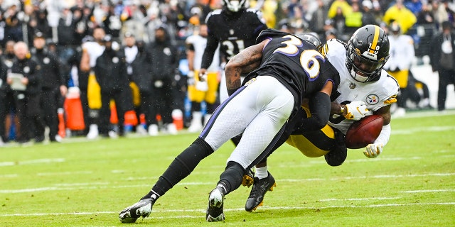 Baltimore Ravens safety Chuck Clark (36) tackles Pittsburgh Steelers wide receiver Diontae Johnson (18) during the first quarter at M&T Bank Stadium Jan. 9, 2022, in Baltimore.