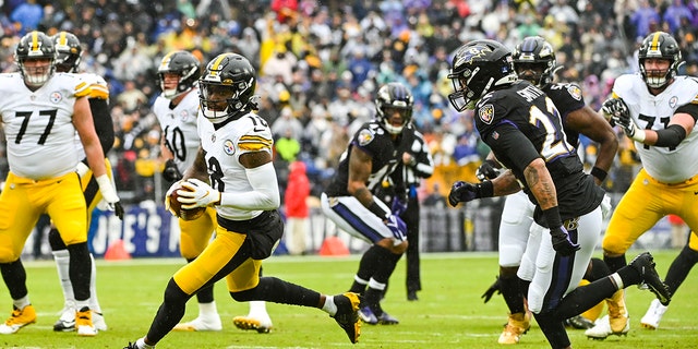 Pittsburgh Steelers wide receiver Diontae Johnson (18) runs after a catch as Baltimore Ravens cornerback Jimmy Smith (22) defense during the first quarter at M&amp;T Bank Stadium on Jan. 8, 2022, in Baltimore.