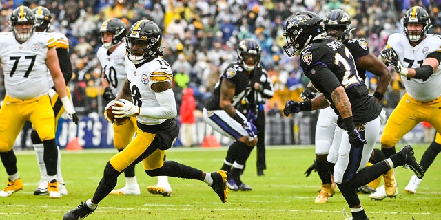 Pittsburgh Steelers wide receiver Diontae Johnson (18) runs after a catch as Baltimore Ravens cornerback Jimmy Smith (22) defense during the first quarter at M&T Bank Stadium on Jan. 8, 2022, in Baltimore.