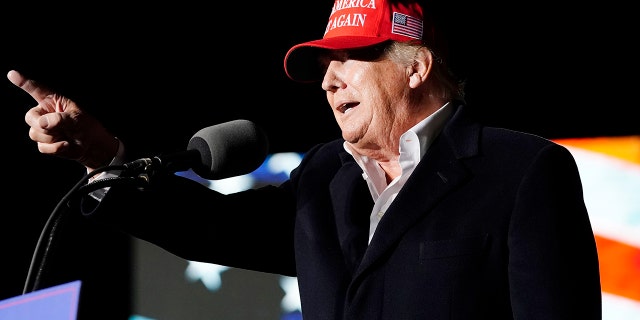 Former President Donald Trump points to the crowd as he speaks at a rally on Jan. 15, 2022, in Florence, Ariz.