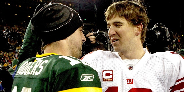Aaron Rodgers of the Green Bay Packers is congratulated by Eli Manning of the New York Giants after their game at Lambeau Field on Dec. 26, 2010 in Green Bay, Wisconsin.