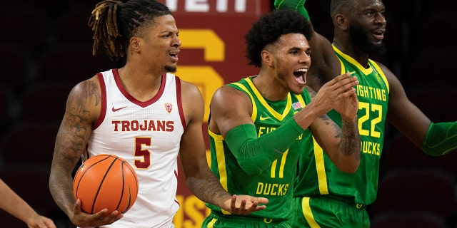 Oregon's Franck Kepnang (22) and Rivaldo Soares (11) react to a foul call on Southern California's Isaiah White (5) during the first half of an NCAA college basketball game Saturday, Jan. 15, 2022, in Los Angeles.