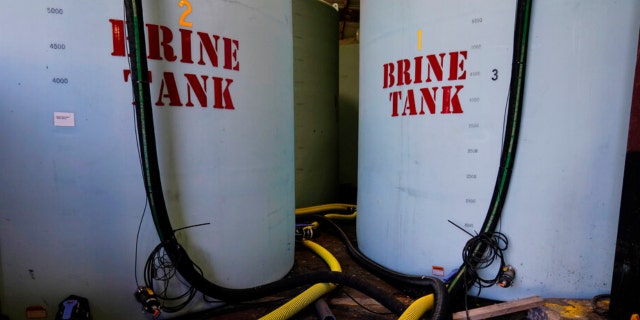 Hoes used to fill brine are seen near brine tank storage bins ahead of a winter storm at the GDOT’s Maintenance Activities Unit location on Friday, Jan. 14, 2022, in Forest Park, Ga. A winter storm is headed south that could effect much of Georgia thru Sunday.