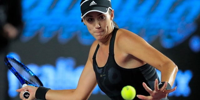 Garbiñe Muguruza of Spain prepares to hit a forehand to Czech Republic's Barbora Krejcikova during a WTA Finals tennis match in Guadalajara, Mexico, Friday, Nov. 12, 2021. Muguruza is seeded No. 3 at the Australian Open, the Grand Slam tennis tournament scheduled to begin Monday, Jan. 17, 2022.