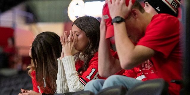 Fans at the University of Georgia's coliseum in Athens, Ga., hold their heads after Alabama converted a first down during the second half of the College Football Playoff championship game Monday, 1 월. 10, 2022.