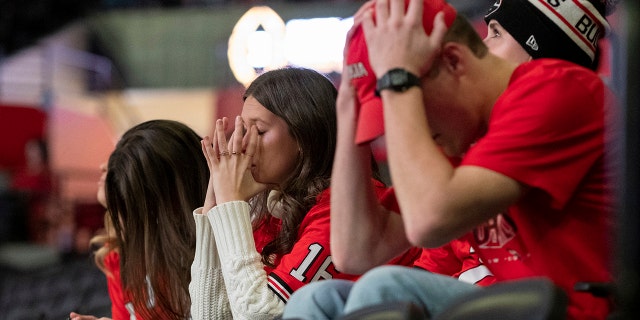 Fans at the University of Georgia's coliseum in Athens, Ga., hold their heads after Alabama converted a first down during the second half of the College Football Playoff championship game Monday, Jan. 10, 2022.