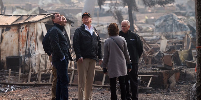 Then-Gov.-elect Gavin Newsom, FEMA Director Brock Long, President Donald Trump, Paradise Mayor Jody Jones and then-Gov. Jerry Brown tour the Skyway Villa Mobile Home and RV Park, during Trump's visit of the Camp Fire in Paradise, California, Nov. 17, 2018.