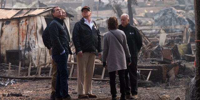 Then-Gov.-elect Gavin Newsom, FEMA Director Brock Long, President Donald Trump, Paradise Mayor Jody Jones and then-Gov. Jerry Brown tour the Skyway Villa Mobile Home and RV Park, during Trump's visit of the Camp Fire in Paradise, California, Nov. 17, 2018.