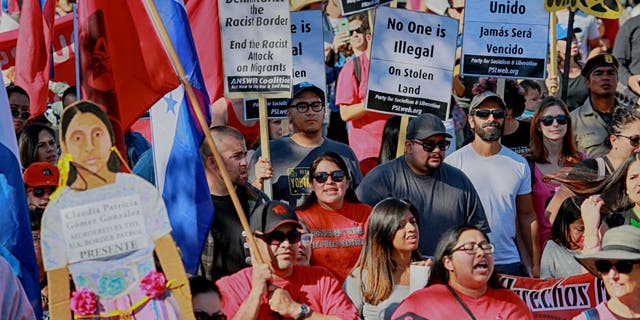 Protesters march along the United States-Mexico border during a rally to show solidarity with the migrant caravan on Nov. 25, 2018. (SANDY HUFFAKER/AFP via Getty Images)