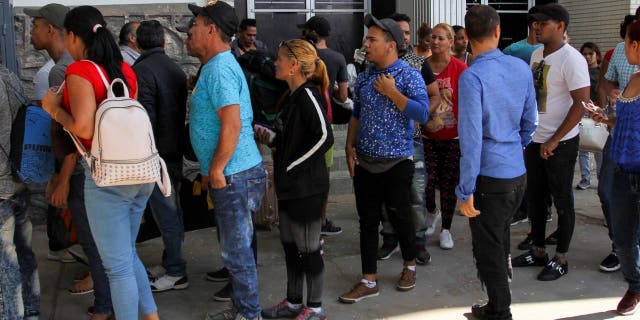Cuban asylum seekers line up for an asylum appointment with U.S. authorities in Ciudad Juarez, Chihuahua state, Mexico, May 31, 2019. - Washington will impose a 5% tariff on all goods from Mexico from June 10, a measure will last until "illegal migrants" stop crossing the country to get to the United States, President Donald Trump said Thursday. (Photo by Herika Martinez/AFP) (Photo credit should read HERIKA MARTINEZ/AFP via Getty Images)