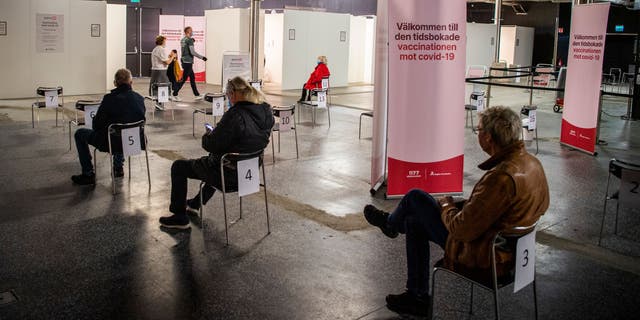 People are waiting to get their vaccines against COVID-19 at a nightclub that became a vaccination center in Stockholm on April 16, 2021.