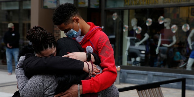 From left, Joselyn Perez, of Methuen, who was at the Boston Marathon in 2013 and survived the bombing, embraces her mother, Sara Valverde Perez, who was hospitalized as a result of the bombing that day, in Boston on April 15, 2021. Joselyns brother Yoelin Perez, who was not at the Marathon during the explosion, embraces them both. 