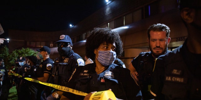 Police place tape outside the entrance of the 7th District police station during a demonstration. (Photo by Evelyn Hockstein/For The Washington Post via Getty Images)Pro