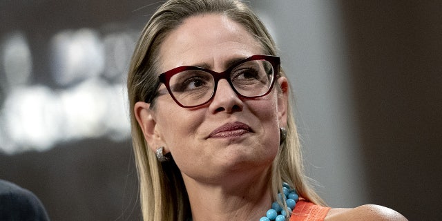 July 28, 2021: Senator Kyrsten Sinema, a Democrat from Arizona, listens during a news conference in the Dirksen Senate Office Building in Washington, D.C., U.S.